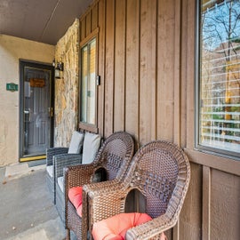 Mountain Charm's relaxing patio with armchairs