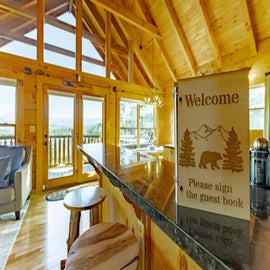 Bear View Cabin’s cozy living area with sign in book